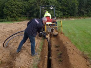 A ground array being installed for a ground source heat pump