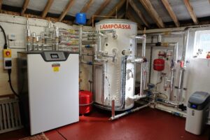 a heating plant room containing a Lampoassa ground source heat pump installed by Finn Geotherm in Suffolk