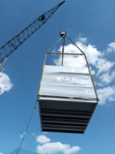 The Panasonic air source heat pump being lifted onto Paragon House in London